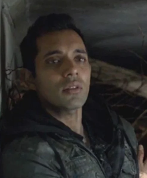 Sachin Sahel The 100 Dr. Eric Jackson Black Coat closeup.webp