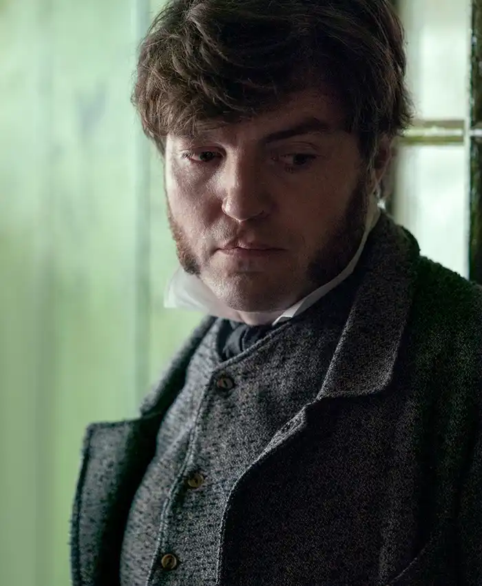 The Wonder William Byrne Gray Coat closeup.webp